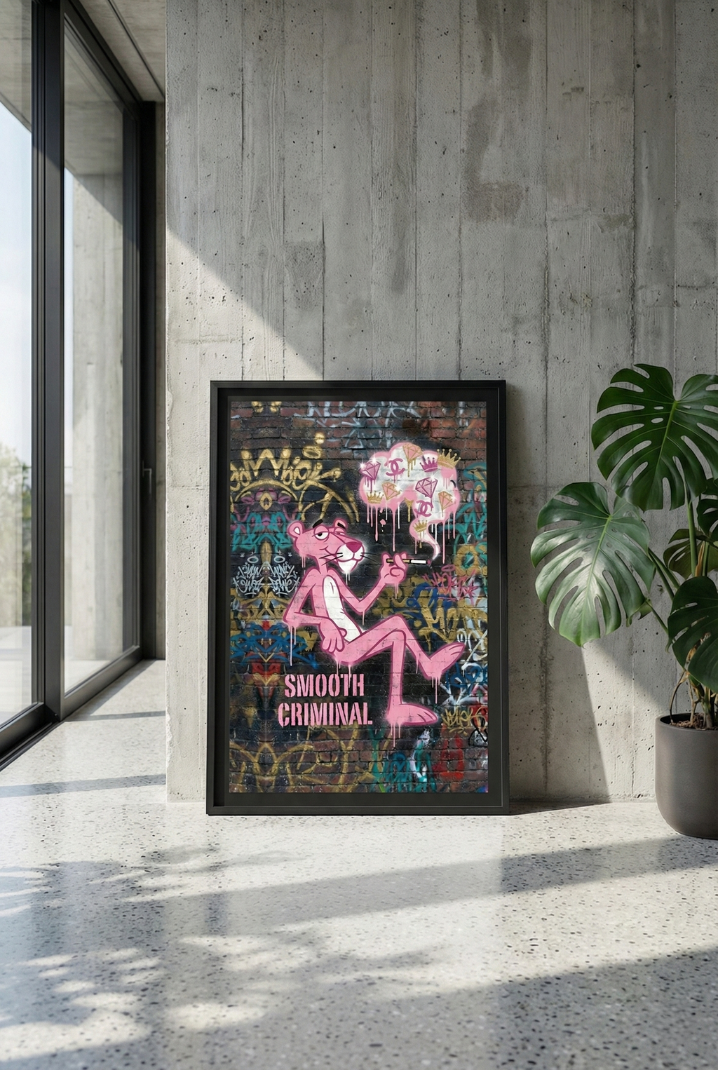 Large premium black framed art of Pink Panther "Smooth Criminal" graffiti by Brzk, leaning against a raw concrete wall in a minimalist luxury apartment with a large Monstera plant next to a modern window.